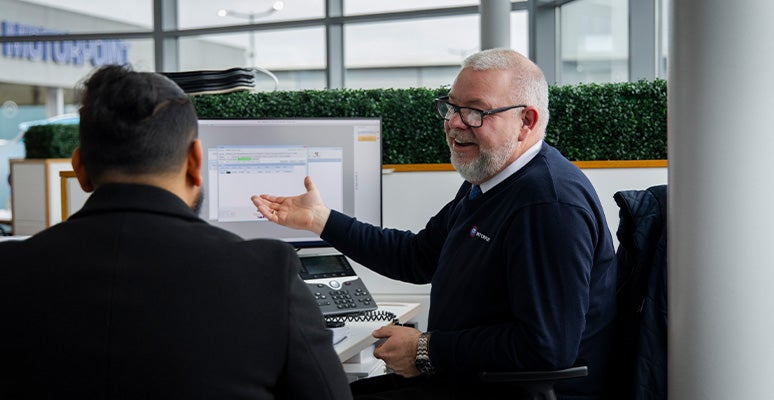 Employee with customer at desk